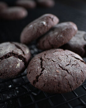 Chocolate crinkle cookies on a cooling rack, entirely vegan, made with avocado