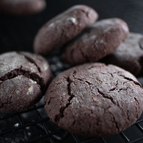 Chocolate crinkle cookies on a cooling rack, entirely vegan, made with avocado