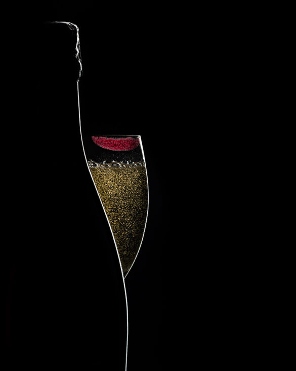 Silhouette of a bottle and champagne glass with lipstick on the rim