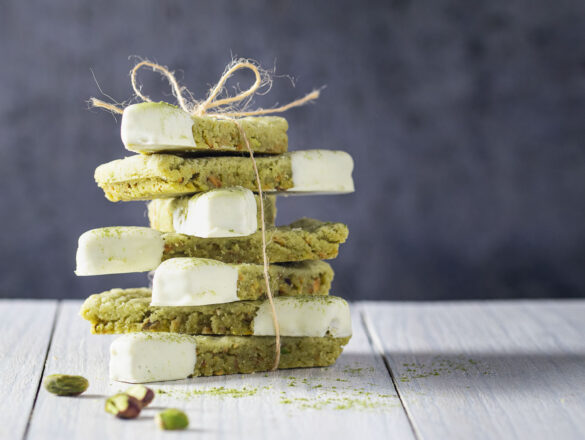 A stack of green Matcha shortbread with white chocolate tips, tied up with a string