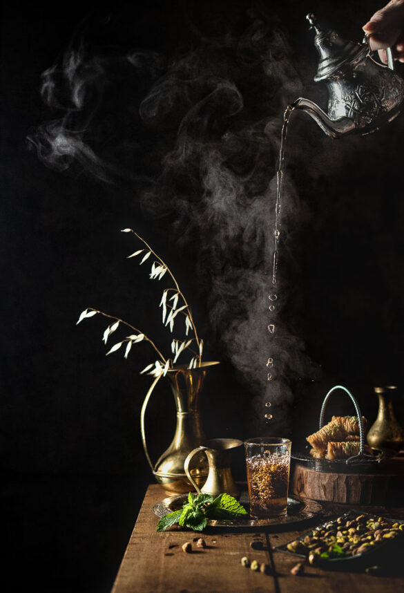 Moroccan mint tea being poured from a classic tea pot from high above