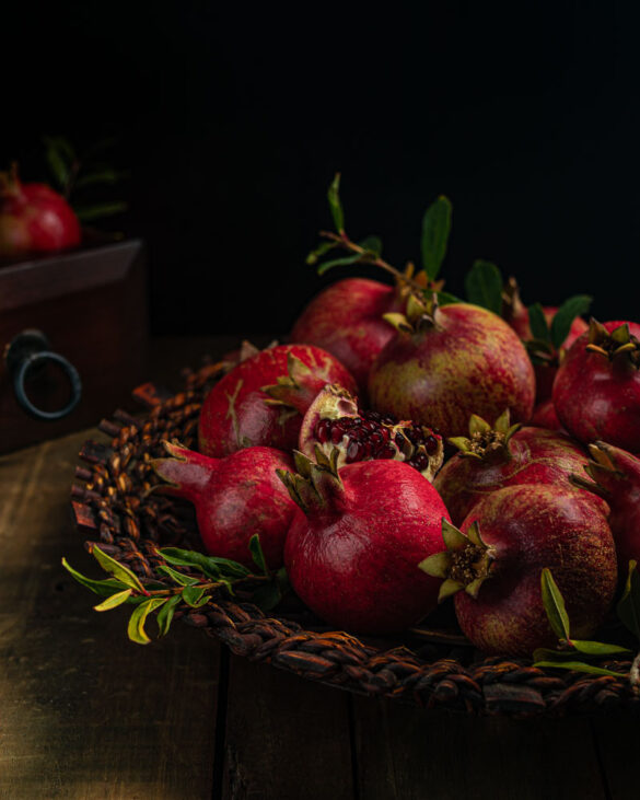 A basket of freshly harvested pomegranates