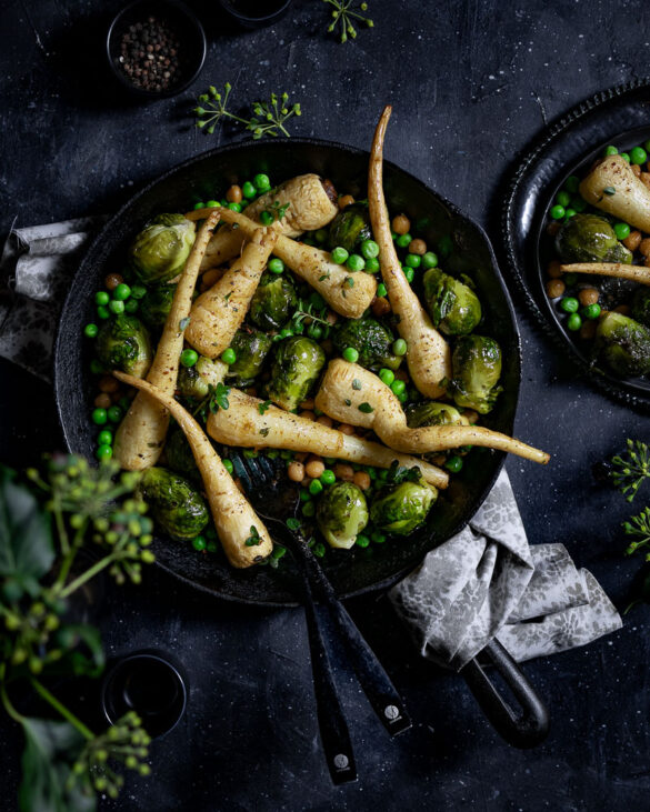 Cast iron pan with roasted parsnips, Brussel sprouts and peas