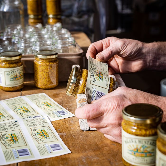 Milawa Mustard jars being labelled by hand