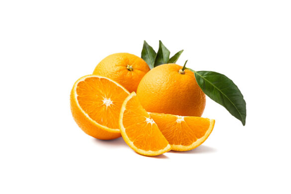 Group of navel oranges, some cut, with leaves