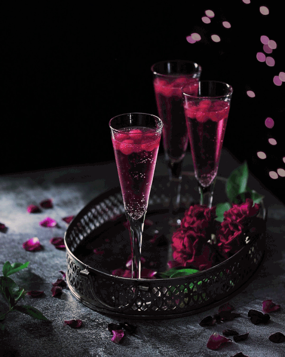 Cinemagraph with champagne glasses holding a red champagne with red moving ice cubes