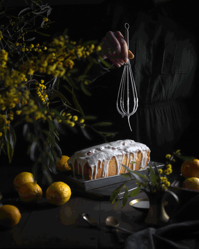 Gif of a lemon cake with icing dropping from a whisk